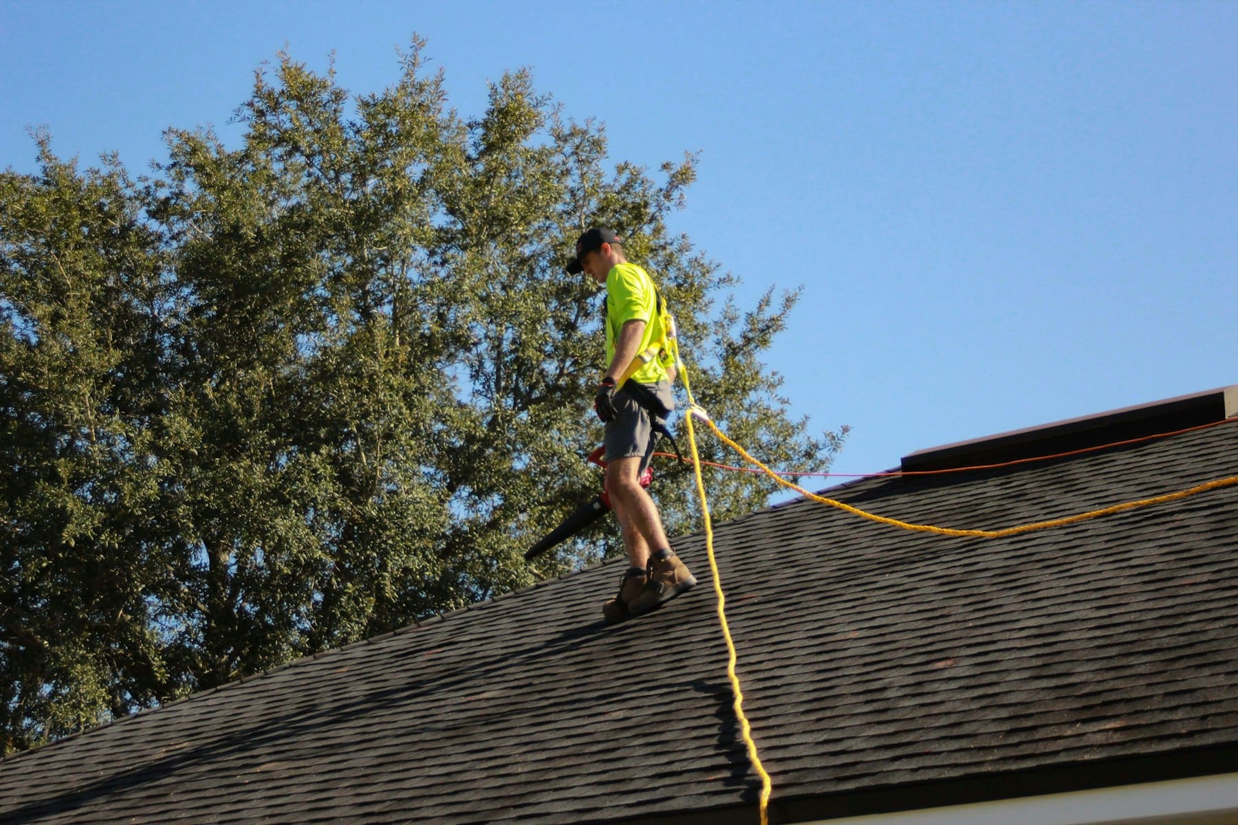 Roofer working safely on a residential roof